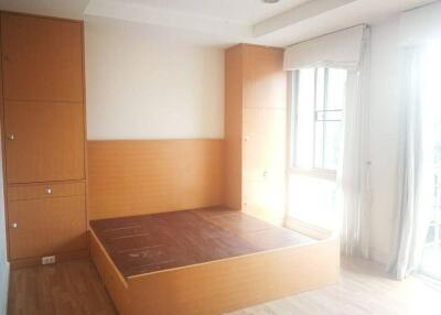 Simple bedroom with built-in wooden furniture