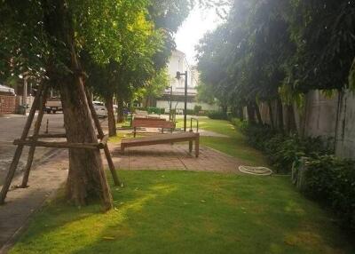 Well-maintained green garden with seating area