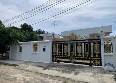 Front view of the modern house with decorative gate