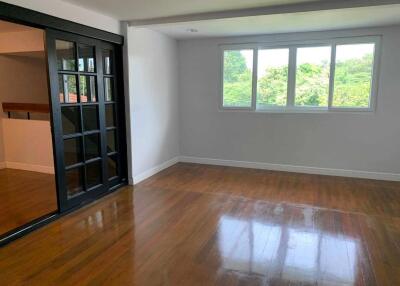 Living room with large windows and wooden floor