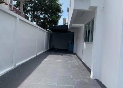 Side walkway of the property with tiled floor and white walls