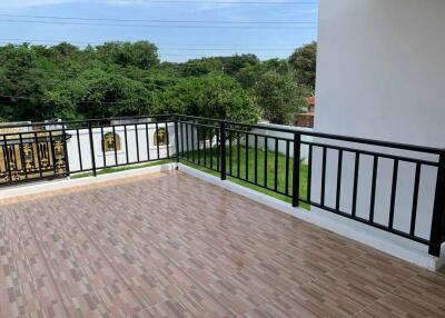 Spacious balcony with tiled floor and black railing