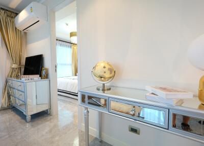 Bedroom with air conditioning, mirrored furniture, and globe decor