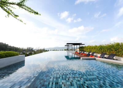 Infinity pool with lounge chairs and scenic view