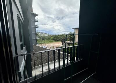 View from balcony with distant buildings and cloudy sky