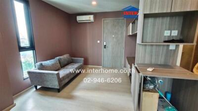 Modern living room with a sofa, air conditioner, and wooden shelving