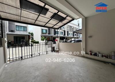 Spacious covered garage area with secure gate and outdoor view