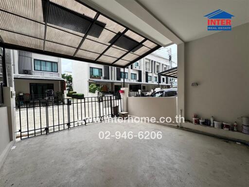 Spacious covered garage area with secure gate and outdoor view