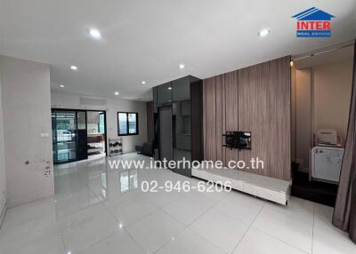 Modern living room with tiled floor and wooden paneled accent wall