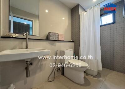 Modern bathroom with sink, toilet, and shower