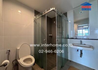 Modern bathroom with glass shower and porcelain fixtures