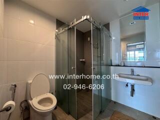 Modern bathroom with glass shower and porcelain fixtures