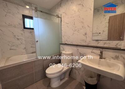 Modern bathroom with marble walls and fixtures