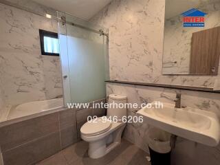 Modern bathroom with marble walls and fixtures