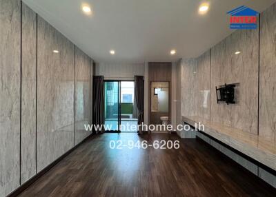 Modern living room with wood flooring and marble wall panels