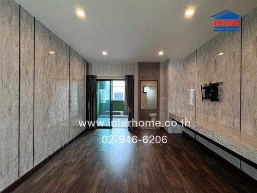 Modern living room with wood flooring and marble wall panels