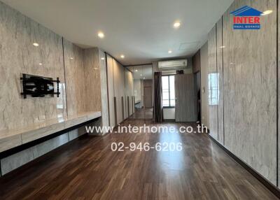 Spacious living room with wooden flooring and built-in features