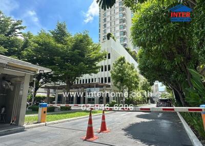 Entrance to a modern residential building with surrounding trees