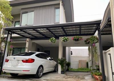 Modern house exterior with a carport and a white car