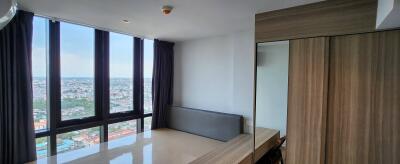 Bedroom with large windows and city view