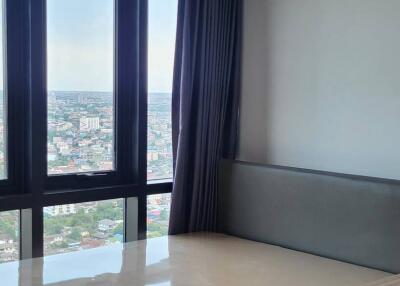 Bedroom with large windows and city view