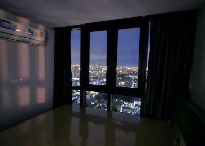 Bedroom at night with city view