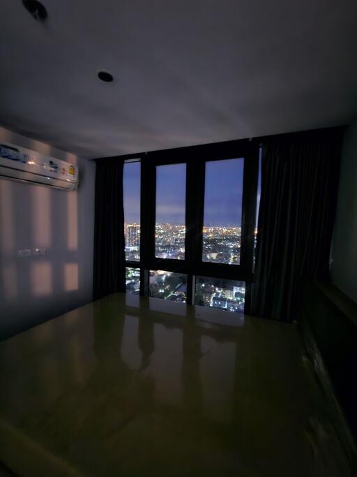 Bedroom at night with city view