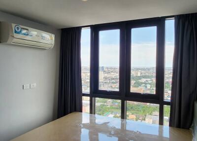 Bedroom with large windows and city view