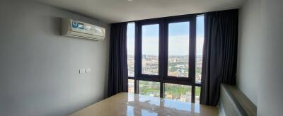 Bedroom with large windows and city view