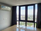 Bedroom with large windows and city view