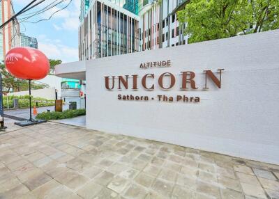 Front view of the Altitude Unicorn Sathorn-Tha Phra building with signage