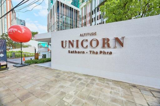 Front view of the Altitude Unicorn Sathorn-Tha Phra building with signage