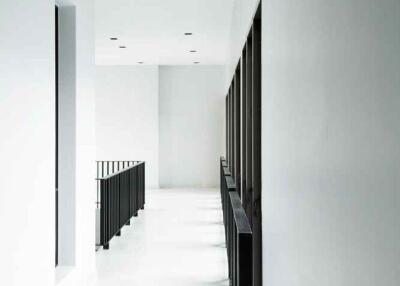 Bright white hallway with modern railing