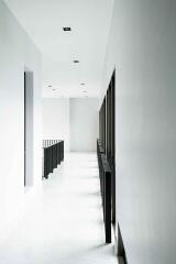 Bright white hallway with modern railing