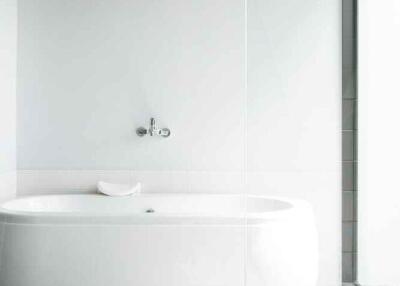 Modern minimalistic bathroom with bathtub and large window