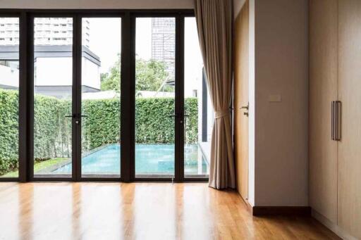 Living room view with large windows overlooking pool area