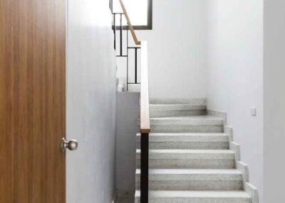 Modern indoor staircase with wooden handrails