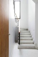 Modern indoor staircase with wooden handrails