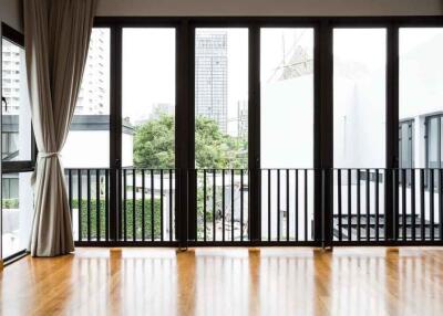 Spacious living room with large windows and city view