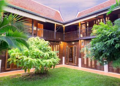 Exterior view of a two-story traditional-style building with greenery