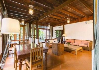 Spacious living room with wooden ceilings and large windows