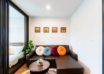 Modern living room with glass partition and comfortable seating