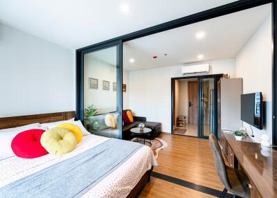 Bright bedroom with work desk and seating area