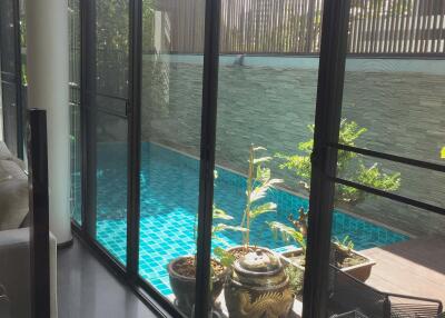 Glass doors opening to a pool area