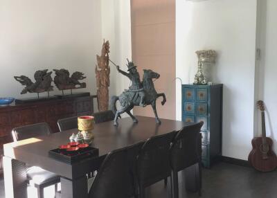 Dining room with table, chairs, decorative items, and air conditioning