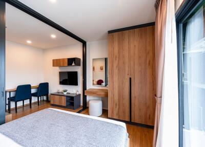 Modern bedroom with wooden furniture and study area