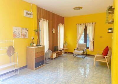 Cozy living room with yellow walls and simple furnishings