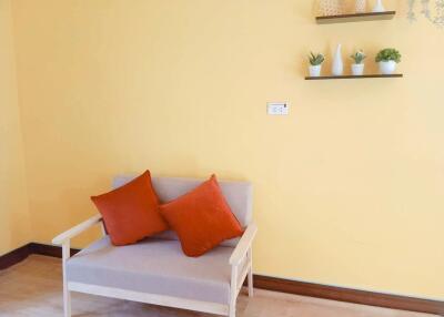 Living room with beige sofa and orange pillows