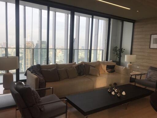 Spacious living room with large windows and city view