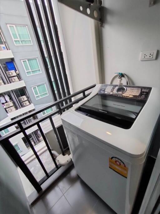 small laundry area with washing machine on balcony